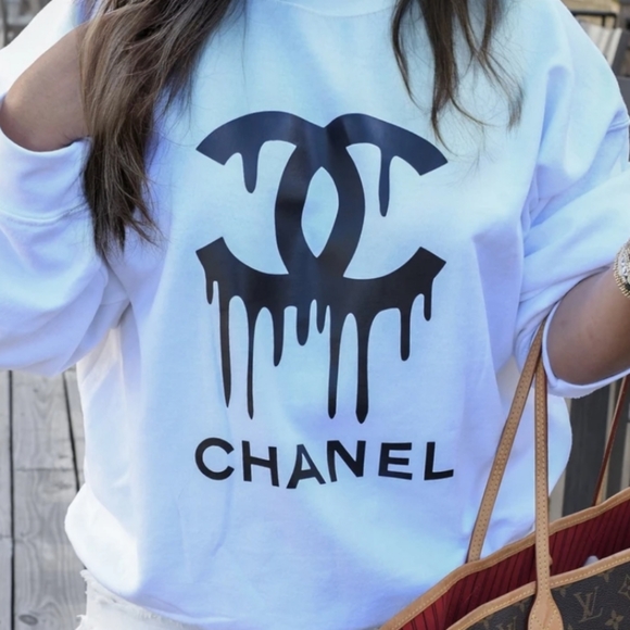 The sweatshirt features a white logo on black background .Designed - Picture 1 of 3